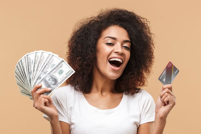 lady holding cash and credit card